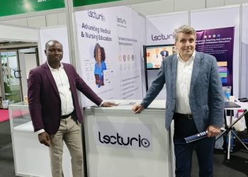 Two men standing together at an exhibition stand