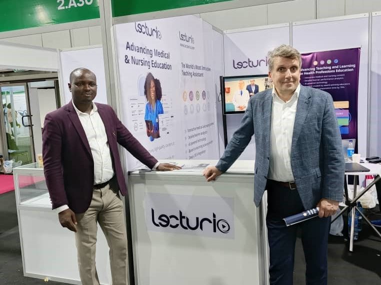 Two men standing together at an exhibition stand