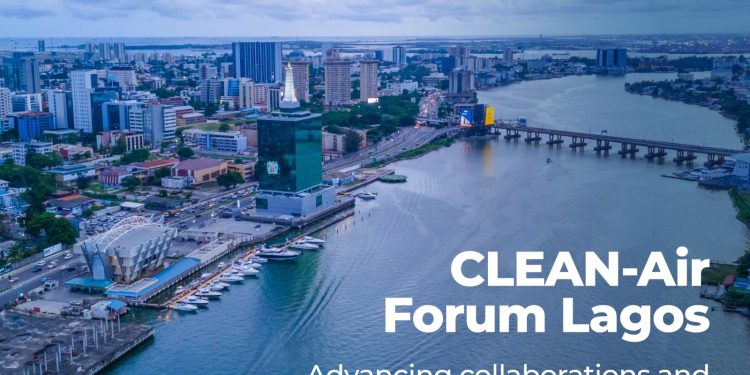 Aerial view of a city with tall buildings, a body of water passing through with a bridge