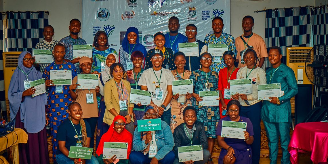 People standing indoor holding placards in their hands