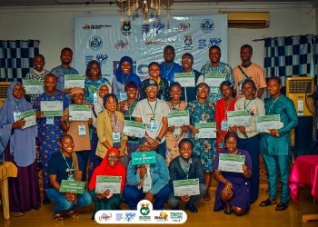 People standing indoor holding placards in their hands