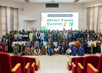 Image of many people sitting and standing indoor