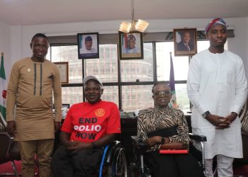 Four people in door. Two are on wheelchair and two are standing