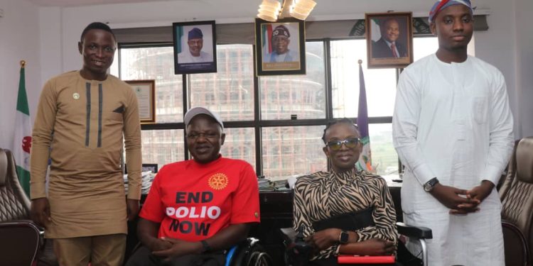 Four people in door. Two are on wheelchair and two are standing