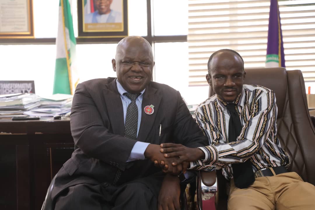 Two men sitting indoors