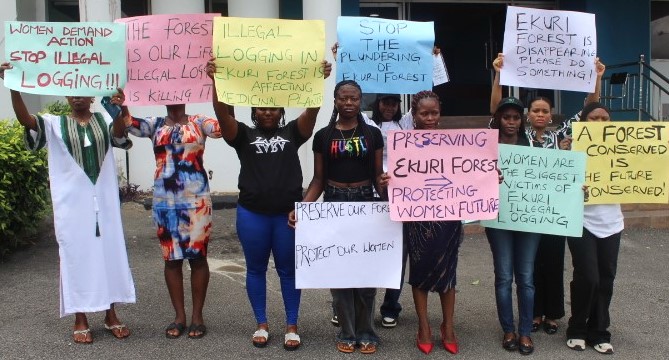 A group of women holding placards standing outdoors