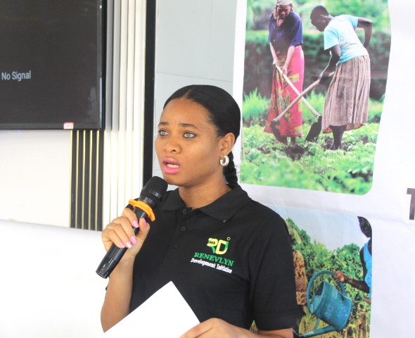 A woman holding a microphone standing  indoors