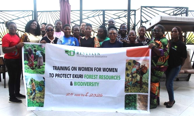 A group of women standing out door holding a banner with the inscription 'Training on women for women to protect ekuri forest resources and biodiversity' 25 March 2026. At the top of the banner is the RDI logo