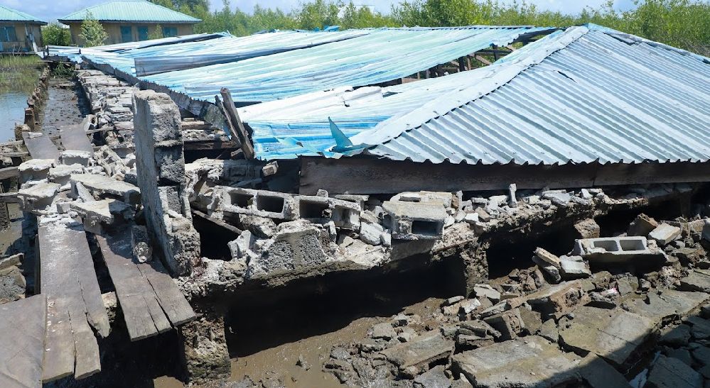 Roof of building damaged with broken and falling block of fence