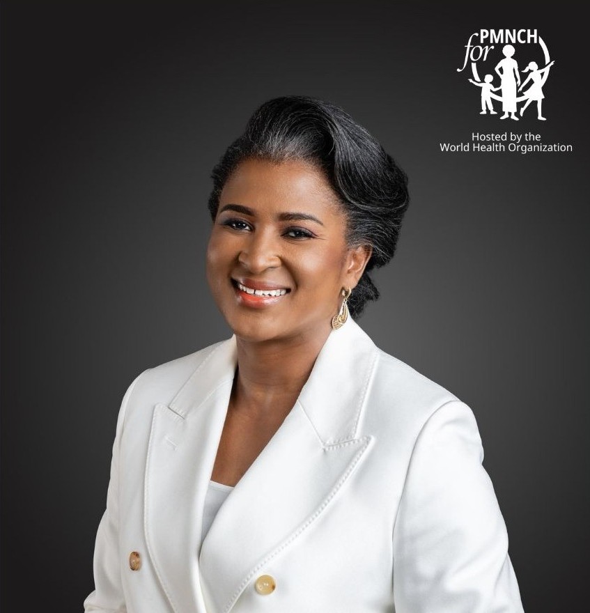 Professional photograph of a woman (Monica Geingos) smiling wearing a white suit.