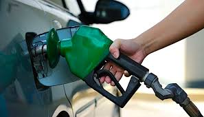 A fuel pump nozzle dispensing petrol into a vehicle