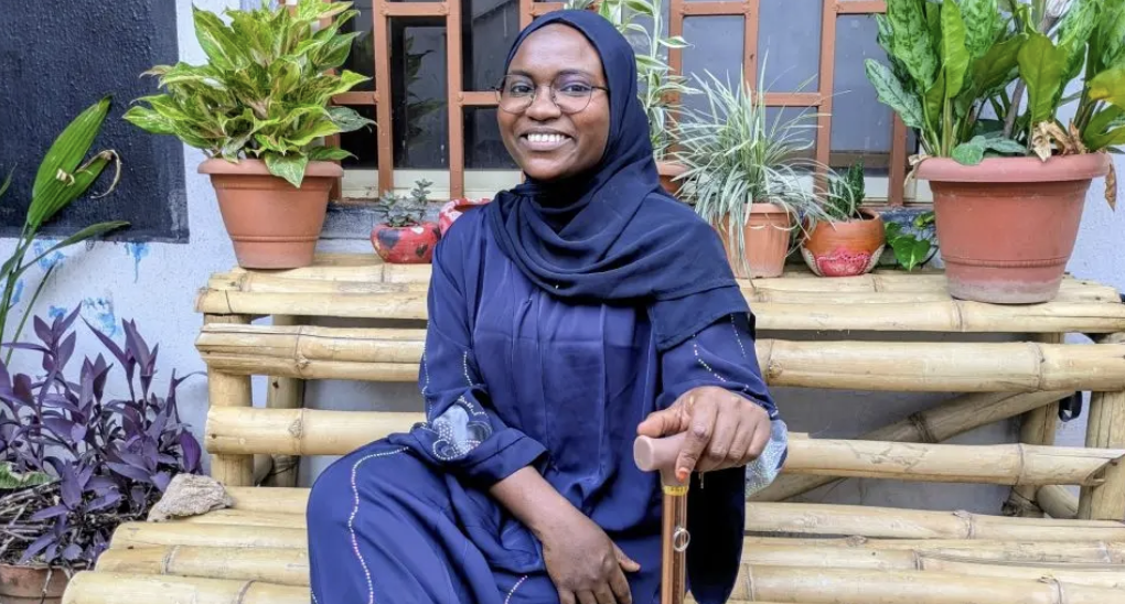 Salma Ja’eh with a walking stick at Open Arts Centre in Kaduna. Photo: Hauwa Saleh Abubakar/HumAngle.