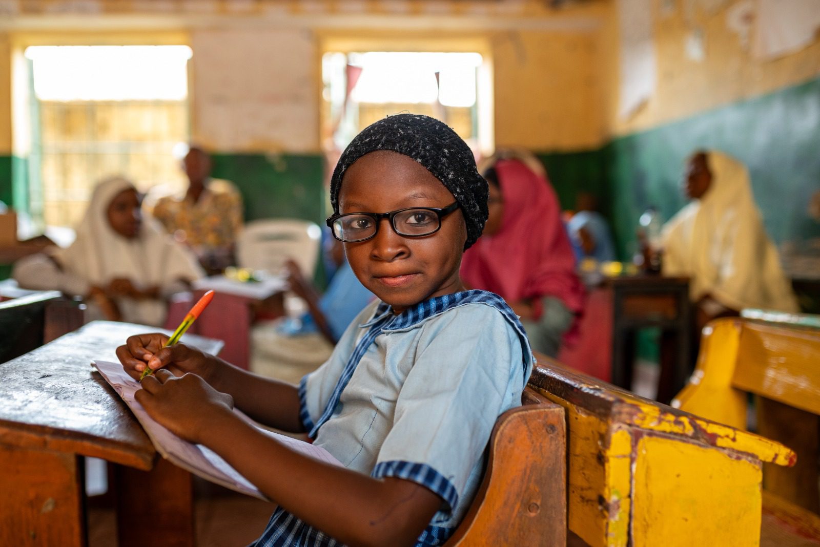 Favour, a student from Kebbi State, was diagnosed with refractive error during an eye health screening supported by Sightsavers. She was provided with glasses, which has helped her to study well. Photo credit: Sightsavers